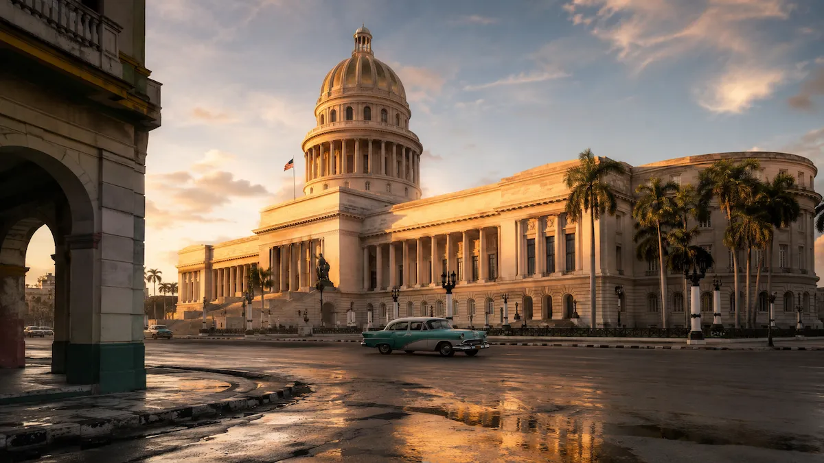 El Capitolio of Havana at golden hour with a classic Cuban car passing by